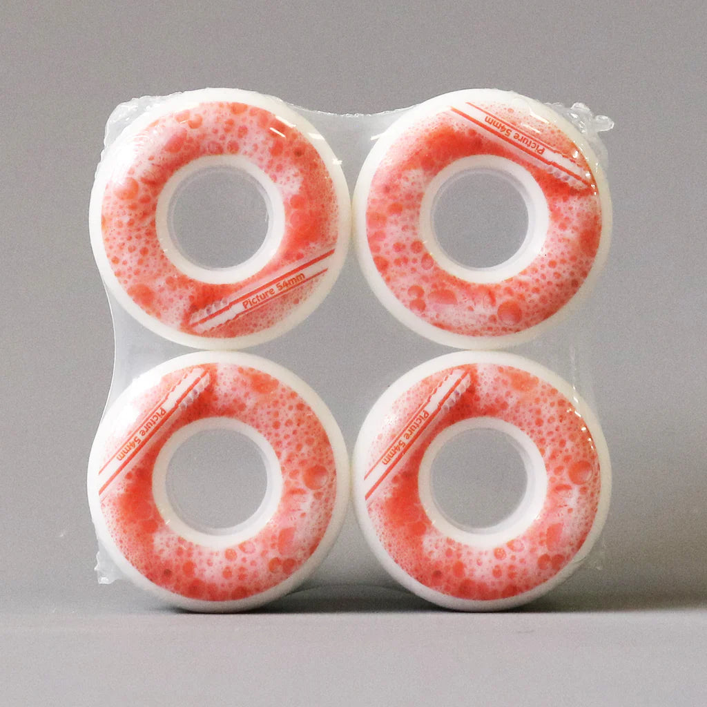 Four red and white skateboard wheels in packaging on a gray background