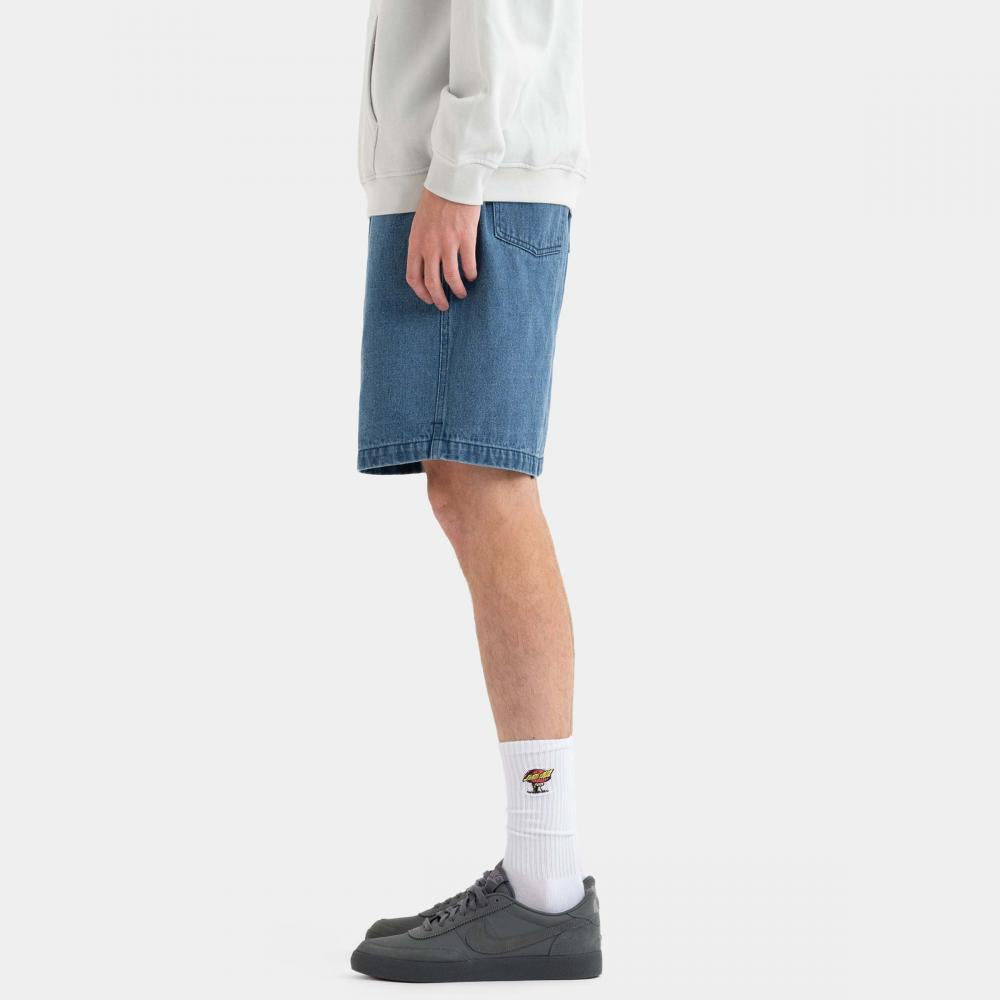 Person wearing a white sweatshirt, blue denim shorts, and gray sneakers on a white background